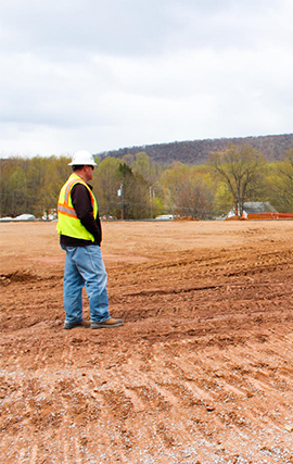 E.J. Breneman Worker Standing on Soil