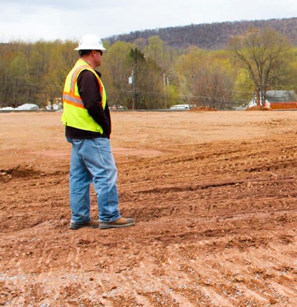 E.J. Breneman Worker Standing on Soil